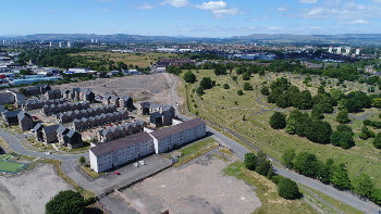 Landscape picture taken by flying drone with housing in foreground and hills on the horizon